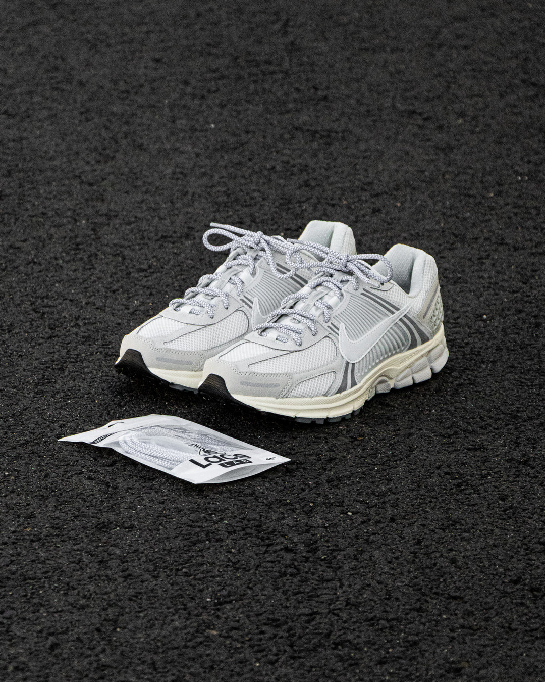 Nike Zoom Vomero with Lace Lab White 3M Reflective Rope Laces on ground
