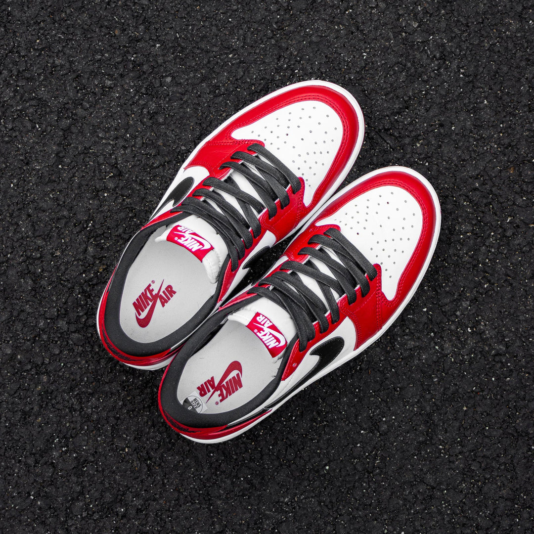 AJ1 Low Chicago on ground with 54” Black Waxed Flat Laces