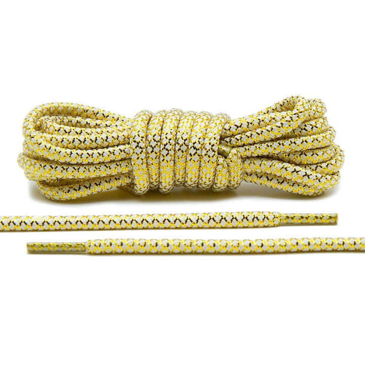 Cordones de cuerda metálicos dorados/blancos.